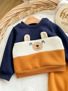 SHEIN Neugeborenen Baby Jungen süßer Farbblock Cartoon Muster Langarm Sweatshirt & Hose mit elastischem Bund Set, Herbst/Winter