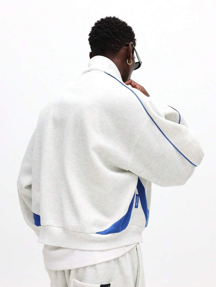 Sweat à capuche demi-zippé avec passepoil contrasté