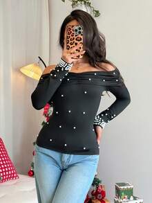 Rafferiza Camiseta de manga larga con hombros descubiertos, volantes y perlas falsas, sexy y elegante, que define la cintura, para mujer en otoño y invierno, para fiestas, Navidad - Negro - Ver 4