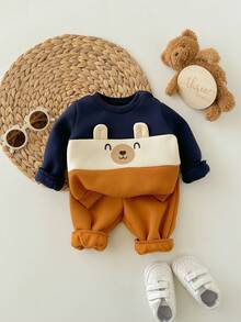 SHEIN Neugeborenen Baby Jungen süßer Farbblock Cartoon Muster Langarm Sweatshirt & Hose mit elastischem Bund Set, Herbst/Winter