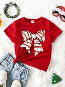 SHEIN Camiseta básica de manga corta con estampado gráfico de lazo de lunares, lema navideño y diseño de dibujos animados lindo y elegante para niña, cómoda para fiestas de Navidad y salidas