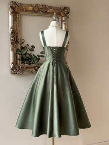 Lovelzi Elegant And Gorgeous Green Satin Fabric Dress For Women. Luxurious Spaghetti Strap Contrast Sequins Pleated Structure. Suspender Fluffy Mid-Dress With Large Hem. Back Strap With Bow. Suitable For Prom Party, Back-To-School Season, Halloween Formal Prom Dress., Semi Formal Dress, For Birthday, Wedding Guest, Graduation, Homecoming