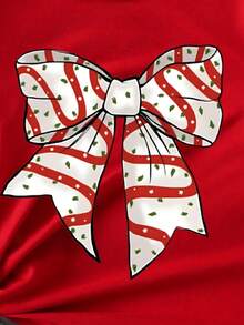 SHEIN Camiseta básica de manga corta con estampado gráfico de lazo de lunares, lema navideño y diseño de dibujos animados lindo y elegante para niña, cómoda para fiestas de Navidad y salidas