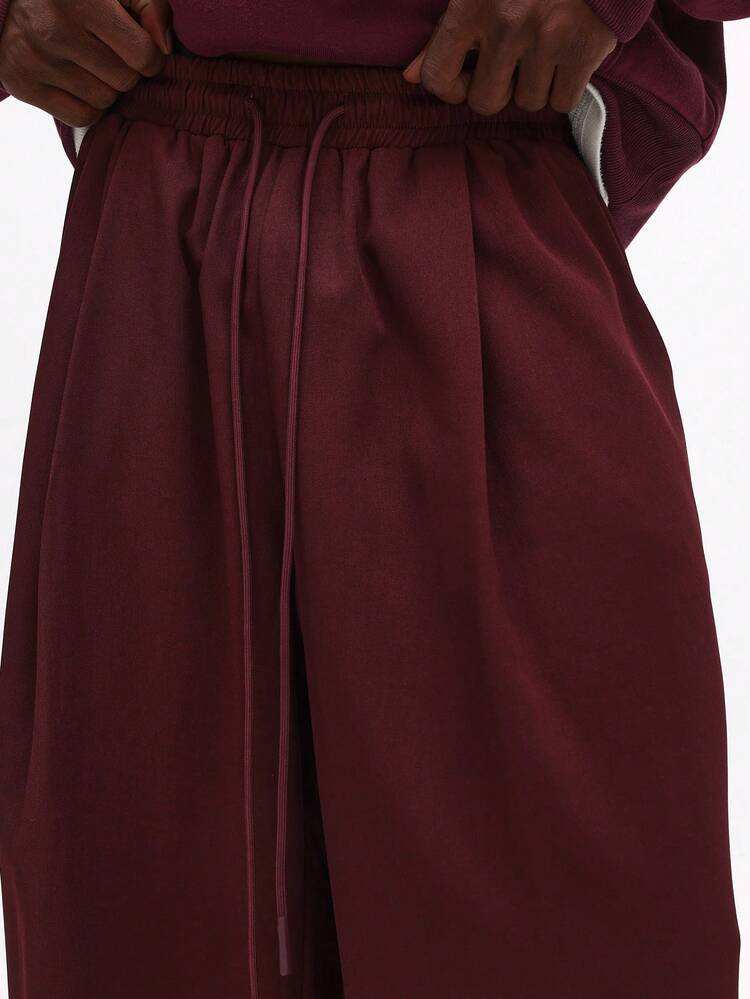Pantalones holgados con pliegues y cordón