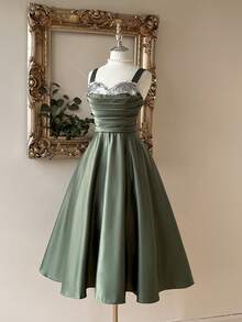 Lovelzi Elegant And Gorgeous Green Satin Fabric Dress For Women. Luxurious Spaghetti Strap Contrast Sequins Pleated Structure. Suspender Fluffy Mid-Dress With Large Hem. Back Strap With Bow. Suitable For Prom Party, Back-To-School Season, Halloween Formal Prom Dress., Semi Formal Dress, For Birthday, Wedding Guest, Graduation, Homecoming