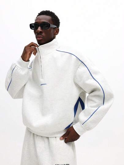 SUMWON 短款超大半拉链套头运动衫，带连帽和撞色蓝色滚边细节，适合休闲街头服饰