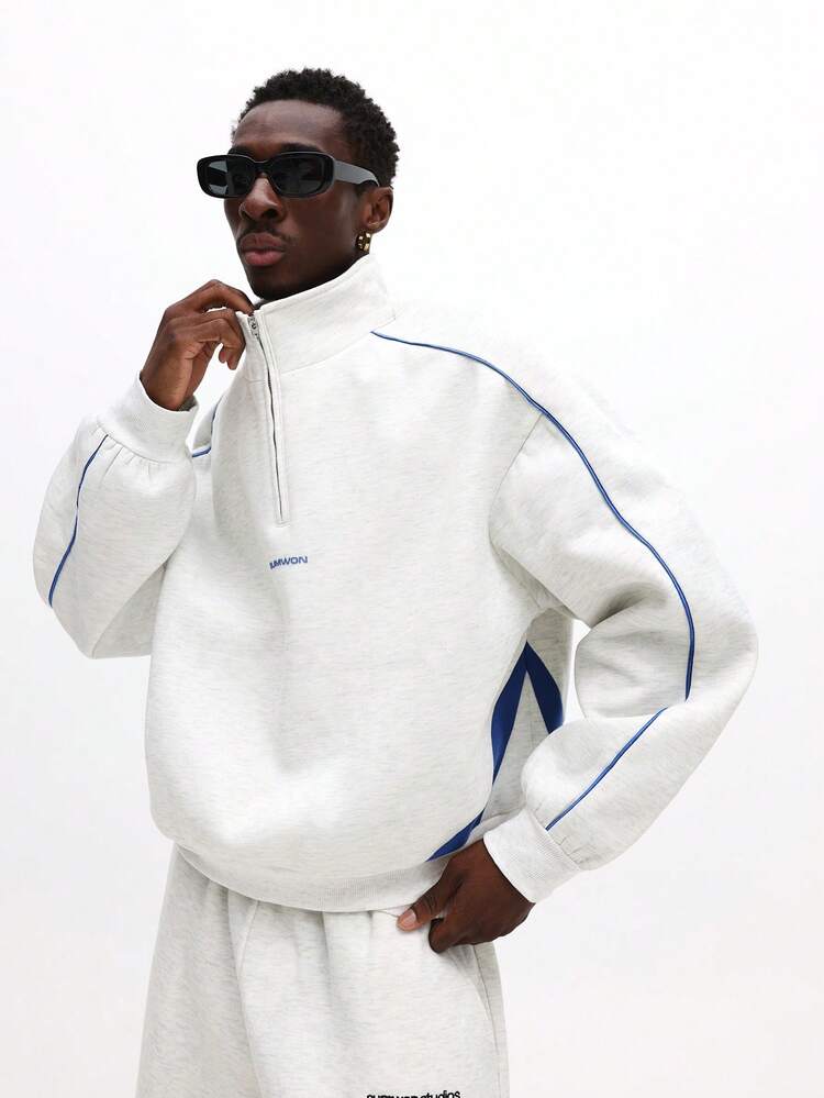 Sweat à capuche demi-zippé avec passepoil contrasté