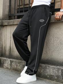 Manfinity Homme Pantaloni de trening casual cu dungi laterale imprimate pentru bărbați, pantaloni de trening negri pentru bărbați, pantaloni de trening cu dungi laterale largi, pantaloni de sală de stradă