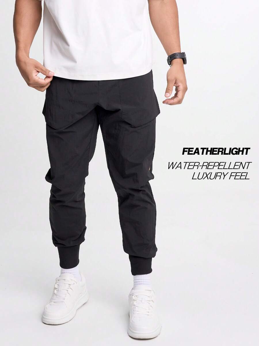 Men's Elastic Waist Zipper Pocket Casual Tapered Sports Pants - Black - View 1