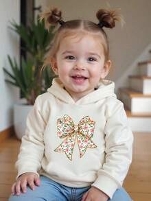 SHEIN 女婴秋季休闲舒适连帽卫衣，粉色花卉箔印花蝴蝶结设计，舒适套头连帽衫，适合幼儿和小女孩的简约清新风格，适合秋冬季，温暖、舒适、时尚休闲装，适合派对、户外野餐、街头摄影、节日、礼物