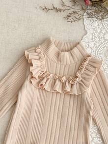 SHEIN Set de 2 piezas de ropa de otoño/invierno para niñas bebés, de 6 meses a 3 años, de estilo callejero de moda en color albaricoque, con top de manga larga asimétrico de cuello alto elástico con volantes y falda corta de cuadros con lazo decorativo en la cintura elástica, cómodo y adorable, para uso casual y al aire libre, también puede usarse como regalo