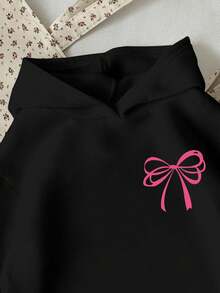 SHEIN Sudadera con gráfico de lazo rosa para adolescentes, cómoda y casual con diseño minimalista de lazo rosa, cuello redondo, corte holgado, adecuada para uso invernal - Negro - Ver 3