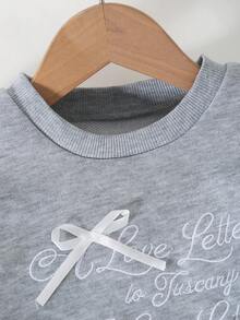 Ensemble de tenues pour filles avec Sweat-shirt ample à manches longues raglan col rond avec accent de nœud en dentelle florale brodée, associé à un legging skinny de couleur unie à taille élastique. Tenue décontractée pour tous les jours et toutes les saisons