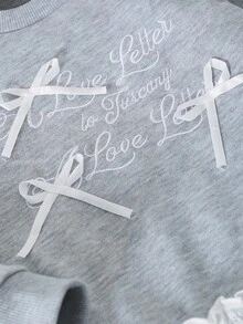 Ensemble de tenues pour filles avec Sweat-shirt ample à manches longues raglan col rond avec accent de nœud en dentelle florale brodée, associé à un legging skinny de couleur unie à taille élastique. Tenue décontractée pour tous les jours et toutes les saisons