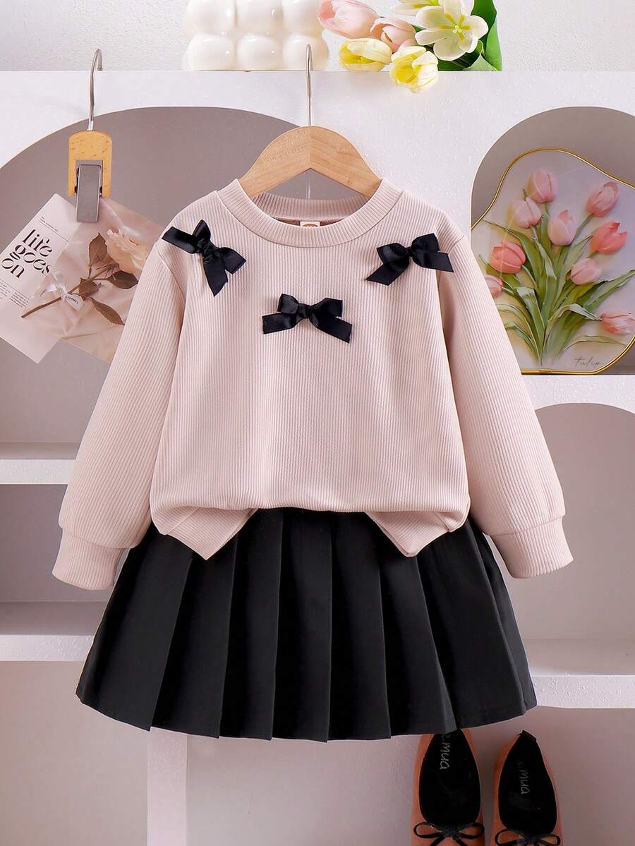 SHEIN Genkimix Kids 2pcs/Set Young Girl Casual Cute Knit Sweatshirt Set, Long Sleeve Bow Top & Black Pleated Skirt, Suitable For Holiday, Autumn