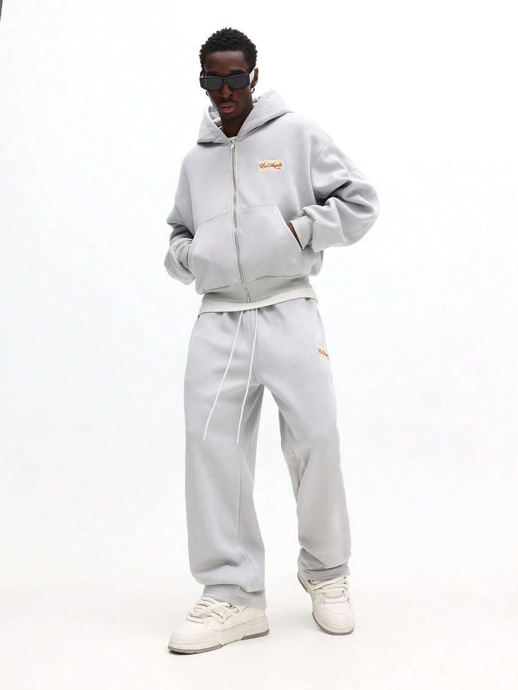 Conjunto de sudadera con capucha y pantalones deportivos con cremallera