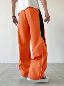 Manfinity EMRG Męskie spodnie dresowe w swobodnym stylu z kolorowymi blokami, ściągaczem i prostymi nogawkami, luźne, długie, patchworkowe, czarne, proste nogawki, spodnie Manfinity Hypemode, wiatrówki, pomarańczowe, spodnie dresowe, męskie, szerokie nogawki, z bocznymi paskami, spodnie sportowe, Streetwear - Pomarańczowy - Zobacz 2