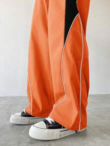 Manfinity EMRG Męskie spodnie dresowe w swobodnym stylu z kolorowymi blokami, ściągaczem i prostymi nogawkami, luźne, długie, patchworkowe, czarne, proste nogawki, spodnie Manfinity Hypemode, wiatrówki, pomarańczowe, spodnie dresowe, męskie, szerokie nogawki, z bocznymi paskami, spodnie sportowe, Streetwear - Pomarańczowy - Zobacz 7