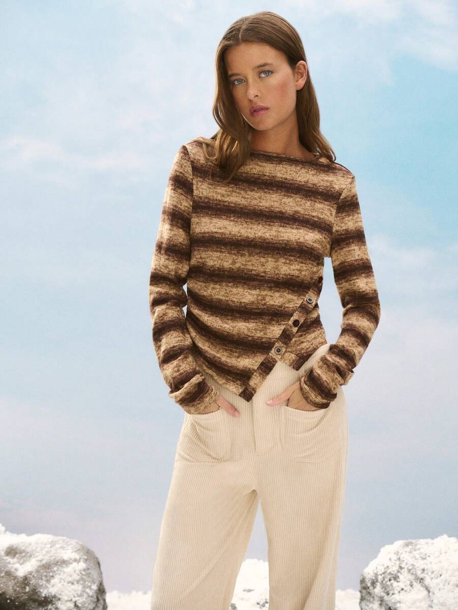 Nöista Cozy Striped Knit Sweater In Brown Tones, Featuring An Asymmetric Button Detail For A Modern Twist. Perfect For Winter Outfits, Christmas Gatherings, Or A Relaxed New Year Look, This Piece Combines Comfort And Style For An Effortlessly Chic Women's Wardrobe.