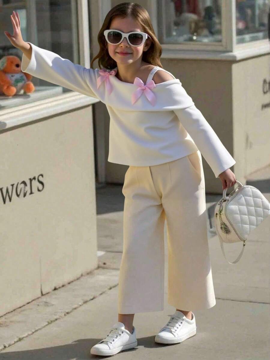 Sparklyn Le nouveau Top à manches longues avec bretelles, design épaules dénudées et nœud papillon pour les préadolescentes est sur le marché. Il est confortable, , élégant, doux, mignon, dynamique, unique et indispensable pour s'habiller. - Blanc - Voir 1