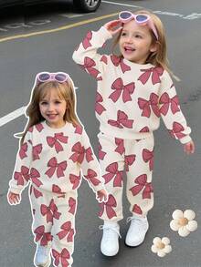 SHEIN Bộ đồ 2 món cho bé gái, gồm áo nỉ dài tay cổ tròn in nơ và quần nỉ, màu hồng, thích hợp cho mùa thu/đông. - Nhiều màu - Xem 1