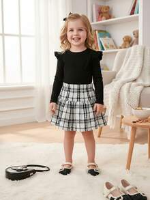 Set di maglietta a maniche lunghe nera e gonna a quadri, semplice e alla moda, per ragazze giovani