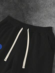 Manfinity EMRG Quần nỉ ống loe rộng rãi có dây rút túi eo họa tiết hoa dành cho nam - màu đen - Xem 5