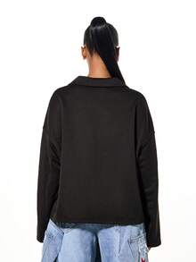 SUMWON WOMEN Oversized Rugby Polo Long Sleeve Graphic Tee With Red Block Print And Yellow Text Logo - Black - View 2