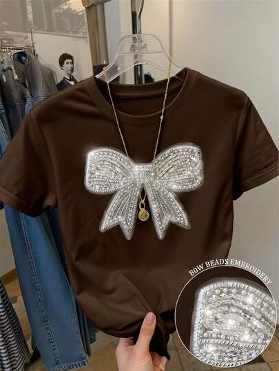Franclia Camiseta de manga corta con cuello redondo y decoración de lazo elegante y lentejuelas para mujer