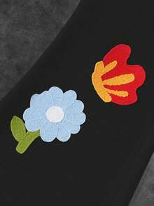 Manfinity EMRG Quần nỉ ống loe rộng rãi có dây rút túi eo họa tiết hoa dành cho nam - màu đen - Xem 2