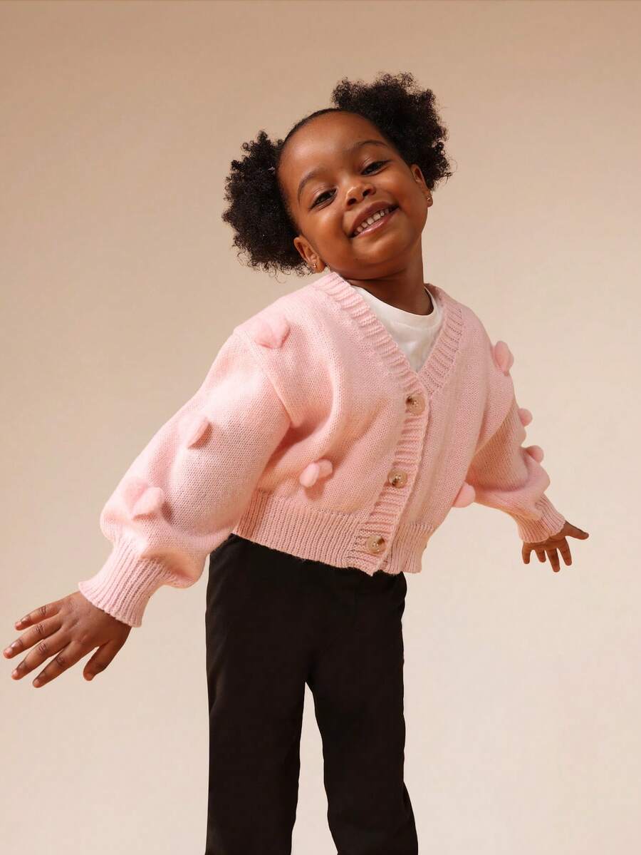 SUMWON Chaqueta de punto corta con botones rosa para niñas, con pompones en forma de corazón y mangas largas - Rosa Pálido - Ver 1
