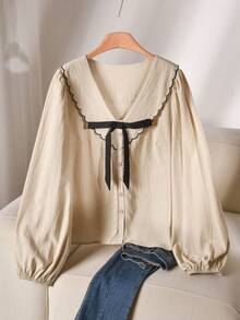 CosyJoli بلوزة قطن بياقة بيتر بان مطرزة بالأصداف مع ربطة أمامية وأكمام فانوس مقاسات كبيرة - لون مشمشي - مشاهدة 1