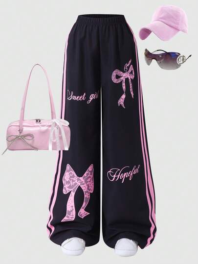 女童休闲黑色裤子，粉色蝴蝶结和字母印花侧条纹松紧腰阔腿裤，适合日常休闲穿着