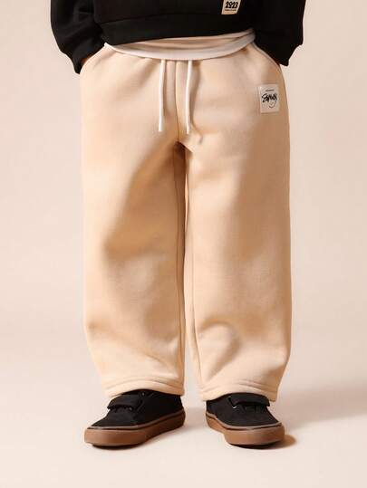 SUMWON Pantalones de chándal de forro polar beige para niños con cintura con cordón y puños acanalados para comodidad y juego diarios