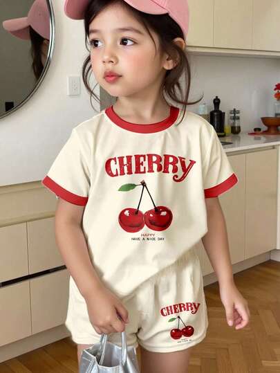 SHEIN Set de 2 piezas de blusa de manga corta y pantalón corto con estampado de cereza vintage y diseño de letra universitaria en color amarillo crema, estilo minimalista casual para niña, apropiado para el verano, de vuelta a la escuela, estilo años 2000, Y2K, verano relajado, vibraciones de vacaciones.