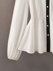 GlowEve Blusa de mujer con diseño de contraste blanco y negro, cuello en V y botones delanteros, elegante silueta de línea A que ciñe la cintura, ideal para maestras