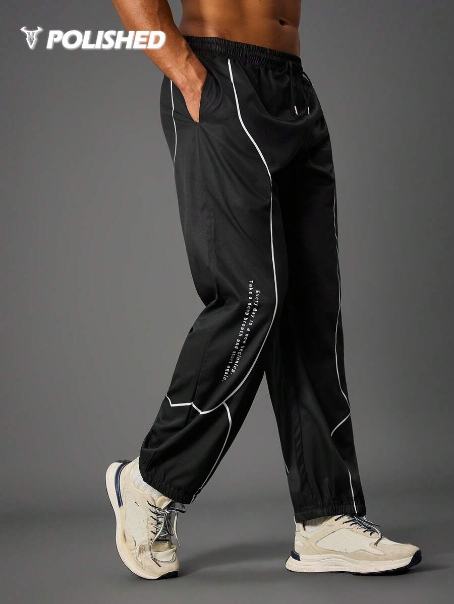 Manfinity Acti Log 男士标语印花抽绳腰带口袋宽松运动裤防风裤男士运动裤黑白健身裤宽松健身服运动裤 - 黑色 - 查看 1
