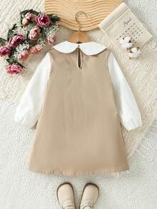 Souflis 这款优雅的学院风彼得潘领连衣裙，饰有纽扣，卡其色和白色相间，适合秋季作为外套穿着，冬季可搭配夹克，适合上学、度假、旅行等场合，是女孩秋冬服装的理想之选，可作为外套穿着，方便叠穿，百搭设计，适合4-7岁女孩。