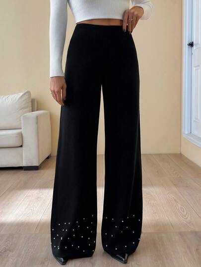 Pantaloni eleganti a vita alta e gamba ampia in maglia con dettagli di orlo a balze impreziositi da perle