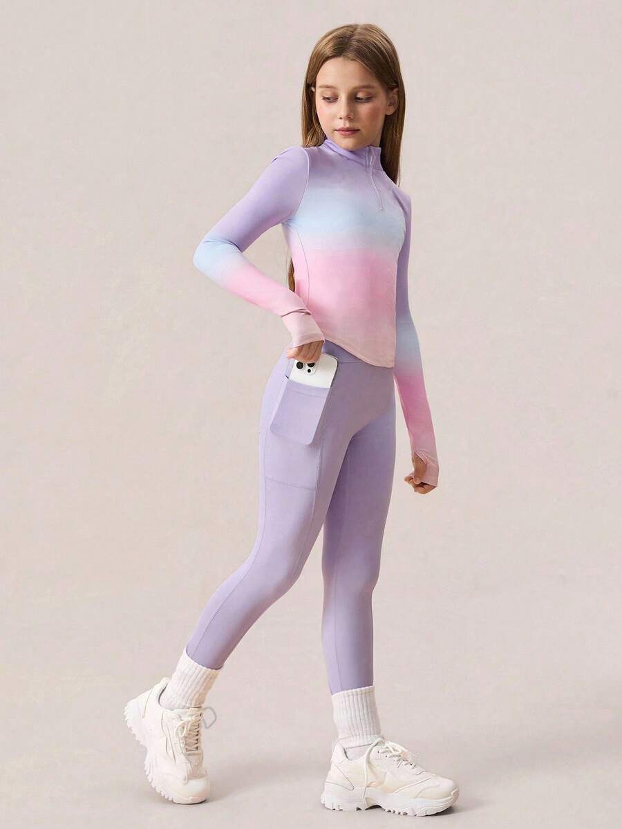 SHEIN 少女服装 一款充满活力的两件套运动套装,专为少女设计,包括一件长袖半开襟拉链上衣,饰有动感的渐变色印花,以及一条时尚的高腰瑜伽裤,采用专业级四向弹力面料制成,具有卓越的灵活性,使其成为普拉提、健身房锻炼和全年休闲户外穿着的多功能选择。 - 彩色 - 查看 1