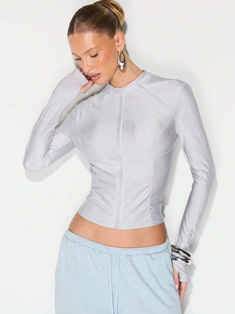 KIZN Blusa esportiva com zíper frontal e mangas compridas.