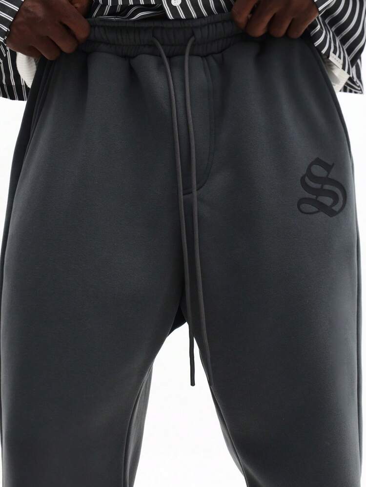 Pantalones deportivos acampanados con logotipo en relieve