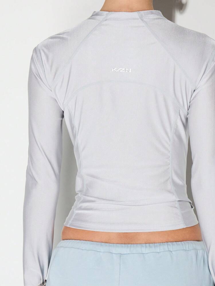 KIZN Blusa esportiva com zíper frontal e mangas compridas.