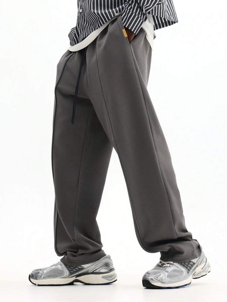 Pantalon de survêtement texturé à plis piqués et cordon de serrage