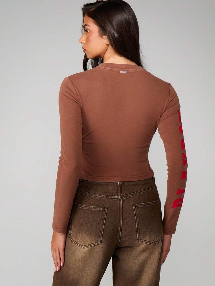 Missguided x Playboy Fitted Long Sleeve Crop Top With Cow Print Bunny Graphic And Red Sleeve Text For Casual Streetwear