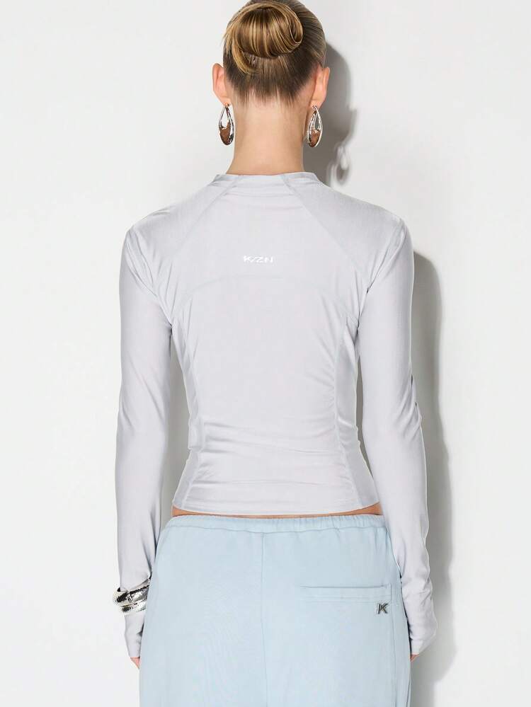 KIZN Blusa esportiva com zíper frontal e mangas compridas.