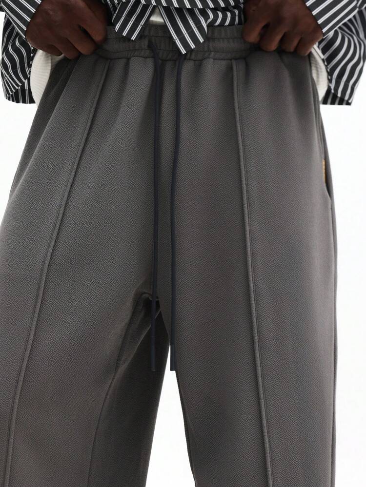 Pantalon de survêtement texturé à plis piqués et cordon de serrage
