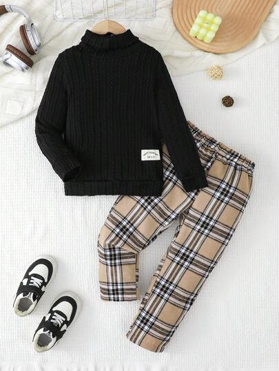 SHEIN 2-delad casual outfit för unga pojkar, svart ribbad tröja + rutiga byxor, i kombination med vita sneakers, för en söt och stilig look! Den klassiska svarta toppen ger djup och vitalitet. I kombination med moderiktiga grå rutiga byxor blir helhetsintrycket avslappnat men ändå raffinerat. Med vita sneakers skapar du enkelt en livfull och energisk look där barnet kan uttrycka sin unika personliga glädje!