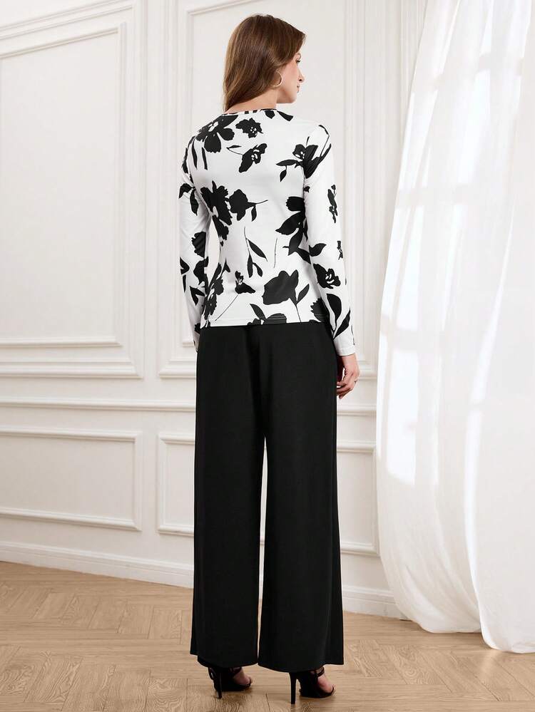 This Elegant Two-Piece Women's Autumn/Winter Set Features A Black And White Floral Print, Exuding Artistic Flair And Eye-Catching Style. The Fitted Long-Sleeved Top Paired With Black Wide-Leg Trousers Creates A Slimming And Streamlined Silhouette. The Classic Black And White Color Scheme Is Simple Yet Sophisticated, Maximizing Style. The Long Sleeves Are Suitable For Spring And Autumn, And Can Be Styled In Various Ways To Create Different Looks For The New Year. Perfect For Stylish Commutes, Casual Gatherings, And Other Occasions, This Set Combines Classic And Modern Elements.