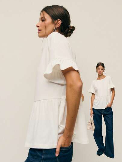 Nöista Elegant White Blouse With Short Ruffle Sleeves And A Flowy Peplum Silhouette. Lightweight And Feminine, It's Perfect For Winter Outfits, Christmas Gatherings, Or A Polished New Year Look. A Timeless Chic Blouse For Women That Pairs Effortlessly With Denim Or Tailored Pants.